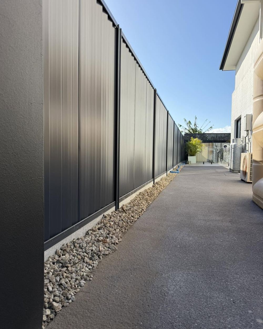 Charcoal Colorbond fence running down a side passage